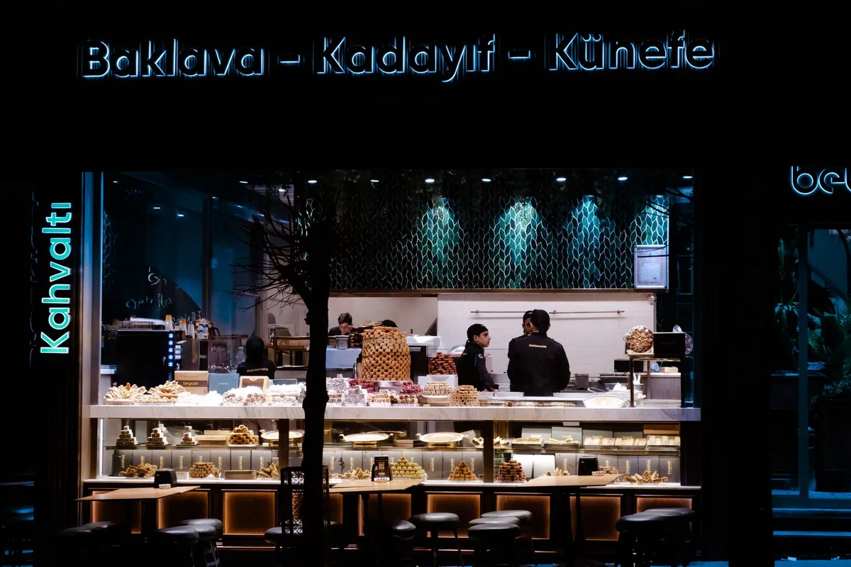 Night view of a bakery café showcasing traditional sweets with illuminated display.